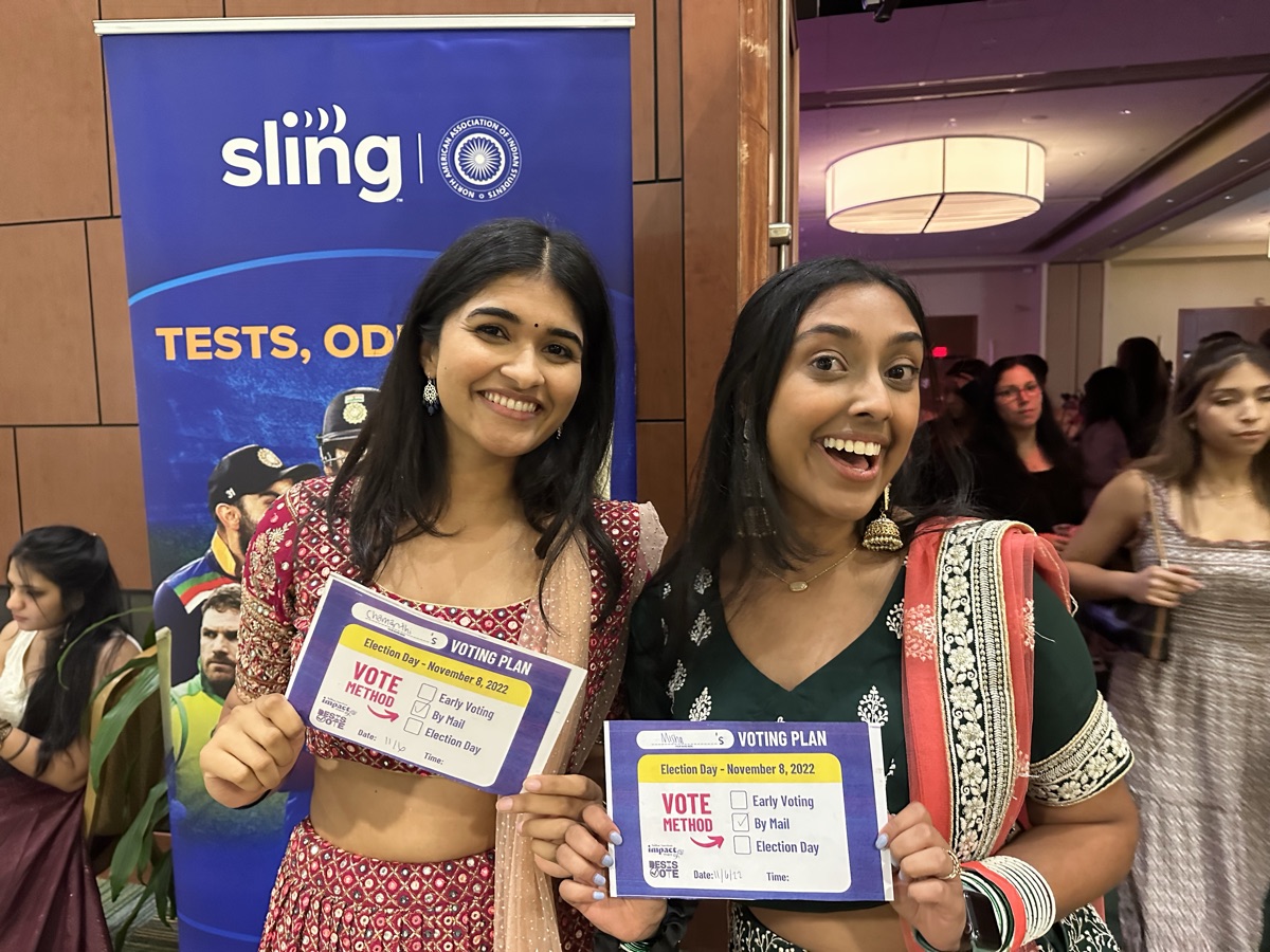 Students holding voting plan cards at a Sling TV campus event